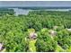 Lush aerial view of property showcasing the house and verdant landscape with serene lake backdrop at 631 May Green Dr, Clover, SC 29710