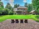 Spacious backyard with well-manicured lawn, featuring an outdoor seating area and a view of the house at 631 May Green Dr, Clover, SC 29710