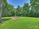 Expansive backyard with lush green grass and a sand pit area with relaxing lounge chairs at 631 May Green Dr, Clover, SC 29710