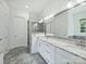 Luxurious bathroom featuring a dual sink vanity, large mirror, and glass-enclosed shower with tiled walls at 631 May Green Dr, Clover, SC 29710
