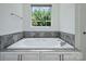 Bathroom with a luxurious soaking tub and tiled surround at 631 May Green Dr, Clover, SC 29710