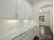 Butler's pantry featuring white cabinets, granite countertop, subway tile backsplash, and dark wood floors at 631 May Green Dr, Clover, SC 29710