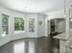 Bright dining area featuring dark wood floors, fireplace, and large windows overlooking the backyard pool at 631 May Green Dr, Clover, SC 29710