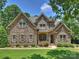 Beautiful stone-clad house with a manicured lawn and mature trees showcasing its curb appeal at 631 May Green Dr, Clover, SC 29710