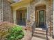 Charming stone front porch with decorative columns, steps and well-maintained landscaping at 631 May Green Dr, Clover, SC 29710