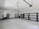 Spacious garage with epoxy flooring, shelving, storage cabinets, and overhead lighting for organization at 631 May Green Dr, Clover, SC 29710
