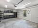 Well-lit garage with pegboard wall, storage shelves, and a utility sink for a functional workspace at 631 May Green Dr, Clover, SC 29710