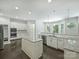 Well-lit kitchen with stainless steel appliances, white cabinetry, granite countertops and dark wood floors at 631 May Green Dr, Clover, SC 29710