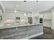 Gourmet kitchen features white cabinets, granite countertops, stainless steel appliances, and pendant lighting at 631 May Green Dr, Clover, SC 29710