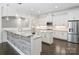Open concept kitchen featuring granite countertops, an island, stainless steel appliances, and dark wood floors at 631 May Green Dr, Clover, SC 29710