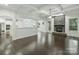 Spacious living room with dark floors, stone fireplace, coffered ceilings, and natural light at 631 May Green Dr, Clover, SC 29710