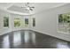 Spacious main bedroom with tray ceiling, hardwood floors, and multiple windows overlooking the landscape at 631 May Green Dr, Clover, SC 29710