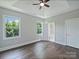 Light-filled main bedroom with tray ceiling, hardwood floors, and an en-suite bathroom at 631 May Green Dr, Clover, SC 29710