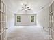Expansive bedroom showcasing tray ceilings, natural light, and plush carpeting at 631 May Green Dr, Clover, SC 29710