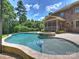 Beautiful pool and spa, with patio space, and a lovely view of the home's exterior at 631 May Green Dr, Clover, SC 29710