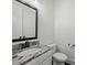 Tastefully designed powder room featuring granite countertops, elegant mirror and modern fixtures at 631 May Green Dr, Clover, SC 29710