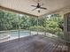 Relaxing screened porch overlooking the backyard, pool, and lush trees at 631 May Green Dr, Clover, SC 29710