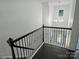 Elegant staircase with dark wood floors and metal balusters, leading to a bright entryway at 631 May Green Dr, Clover, SC 29710