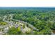 Aerial view of a neighborhood surrounded by trees, with homes arranged along quiet streets at 6430 Matlea Ct, Charlotte, NC 28215