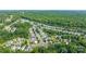 An aerial view showing homes with green lawns bordering wooded areas and streets in a community at 6430 Matlea Ct, Charlotte, NC 28215