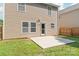 View of the back of the home showing the neutral siding and the small patio at 6430 Matlea Ct, Charlotte, NC 28215