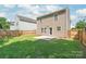 View of the backyard and home featuring fenced yard and small patio at 6430 Matlea Ct, Charlotte, NC 28215