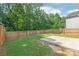 The backyard features a small patio and is lined with a wooden fence at 6430 Matlea Ct, Charlotte, NC 28215
