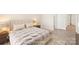 Comfortable staged bedroom with soft lighting, a plush bed, and a soothing color scheme at 6430 Matlea Ct, Charlotte, NC 28215