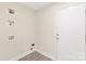Functional laundry room with washer hookups and a white door, ideal for efficient chore management at 6430 Matlea Ct, Charlotte, NC 28215