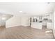 Open-concept living space with hardwood floors that connects the living room and kitchen areas at 6430 Matlea Ct, Charlotte, NC 28215