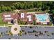 Aerial view of community clubhouse featuring swimming pool, parking, beautiful landscaping, and surrounding trees at 7057 Shenandoah Dr, Fort Mill, SC 29707