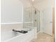 Inviting bathroom showcases a luxurious soaking tub and a separate glass-enclosed shower at 7057 Shenandoah Dr, Fort Mill, SC 29707