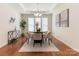 Bright dining room featuring a round table, stylish chairs, and elegant decor with a decorative ceiling and wood floors at 7057 Shenandoah Dr, Fort Mill, SC 29707