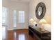 Bright entryway featuring hardwood floors, a decorative mirror, and a glass paneled front door at 7057 Shenandoah Dr, Fort Mill, SC 29707