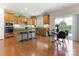 Open kitchen with wood cabinets, stainless steel appliances, granite countertops, and an eat-in area at 7057 Shenandoah Dr, Fort Mill, SC 29707