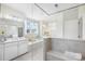 Bright bathroom featuring a soaking tub, tiled shower, double vanity, and natural light at 7058 Cloer Ct, Charlotte, NC 28214