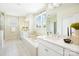 Bright bathroom featuring double sinks, a large soaking tub, and a garden view at 7058 Cloer Ct, Charlotte, NC 28214