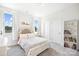 Bright bedroom with carpet, a closet, a bookshelf and two windows with colorful curtains at 7058 Cloer Ct, Charlotte, NC 28214