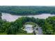 Aerial view of a community pool area with multiple pools, a clubhouse, and lake views at 7058 Cloer Ct, Charlotte, NC 28214