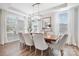 Formal dining room boasts modern lighting, large windows, and ample seating for gatherings at 7058 Cloer Ct, Charlotte, NC 28214