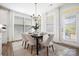 Bright dining room with modern chandelier, lots of natural light, and elegant dining set at 7058 Cloer Ct, Charlotte, NC 28214