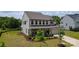 Side view of a beautiful two-story home featuring a landscaped yard, black fenced yard, and covered porch at 7058 Cloer Ct, Charlotte, NC 28214