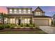 Charming two-story home featuring a manicured front yard and attached two-car garage at 7058 Cloer Ct, Charlotte, NC 28214