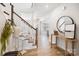 Bright foyer with hardwood floors, staircase, and decorative console table at 7058 Cloer Ct, Charlotte, NC 28214