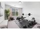 Bright home gym featuring weight-lifting equipment, free weights, and a large window for natural light at 7058 Cloer Ct, Charlotte, NC 28214