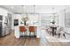 Modern kitchen with island, stainless appliances and adjoining dining area at 7058 Cloer Ct, Charlotte, NC 28214