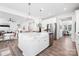 Modern kitchen boasts stainless steel appliances, a large island, and an open floor plan, perfect for entertaining at 7058 Cloer Ct, Charlotte, NC 28214