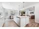 Open-concept kitchen with island, stainless steel appliances, and a view of the dining and living areas at 7058 Cloer Ct, Charlotte, NC 28214