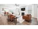Open-concept living space with fireplace, comfortable seating, and hardwood floors at 7058 Cloer Ct, Charlotte, NC 28214