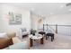 Cozy loft area featuring comfortable seating, a stylish coffee table, and a neutral color scheme at 7058 Cloer Ct, Charlotte, NC 28214